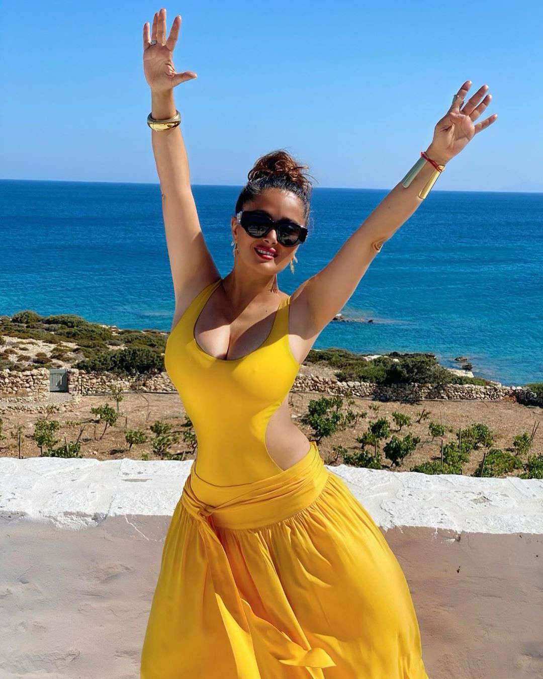 Salma Hayek Pinault Celebrates 54th Birthday in Vibrant Yellow Cutout Swimsuit | PEOPLE.com