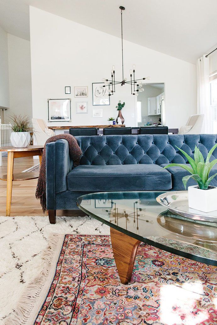 How To Layer Your Rugs Like A Pro, Red Rug Blue Couch
