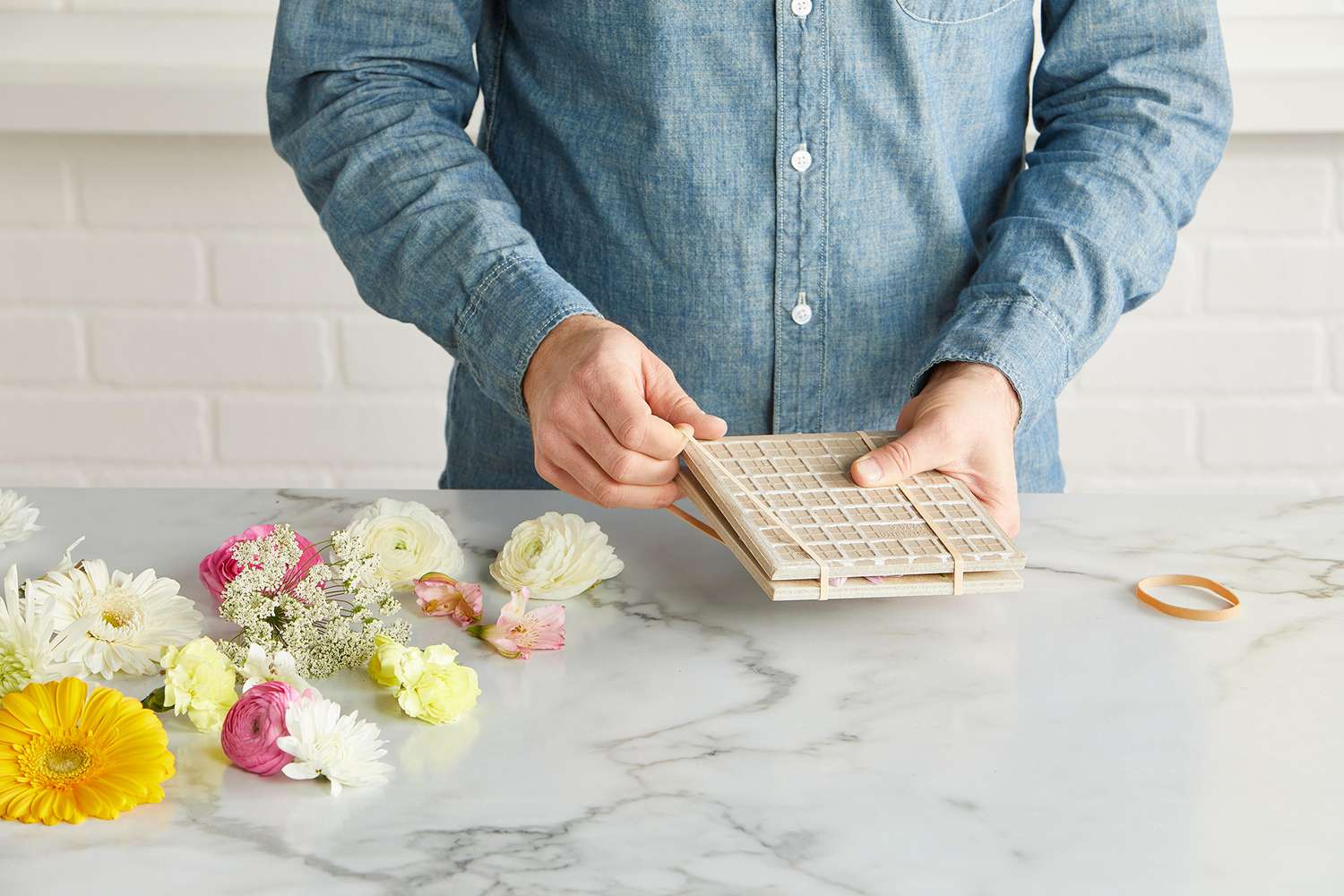 rubber bands rapped around tile squares to press flowers